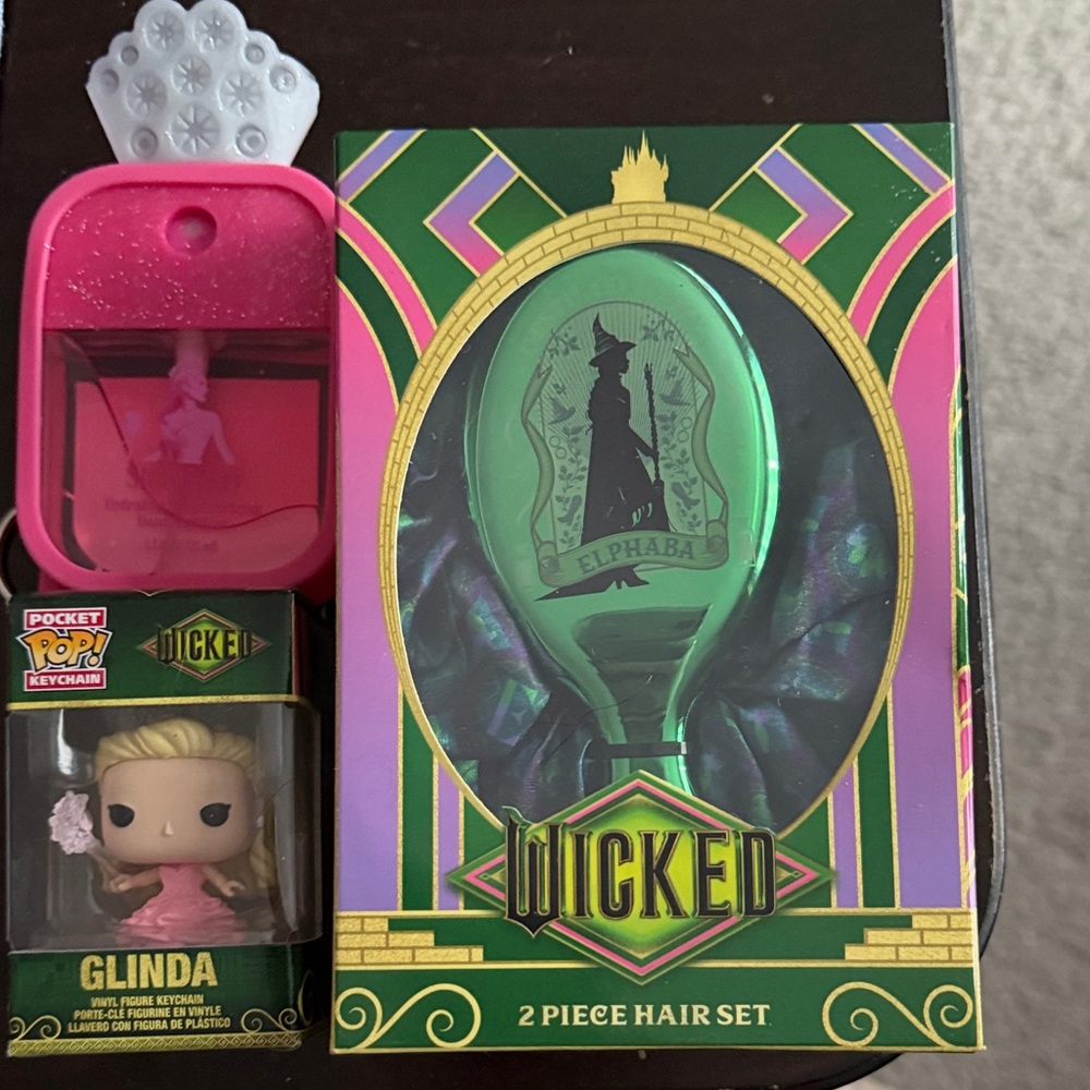 Wicked items: Hair brush. Mini Glinda POP keychainGlinda Hand Sanitizer Keychain